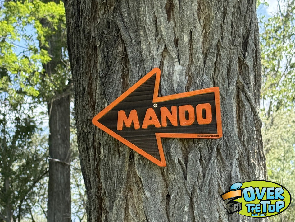 Custom directional Mando course sign mounted on tree by Over The Top Disc Golf